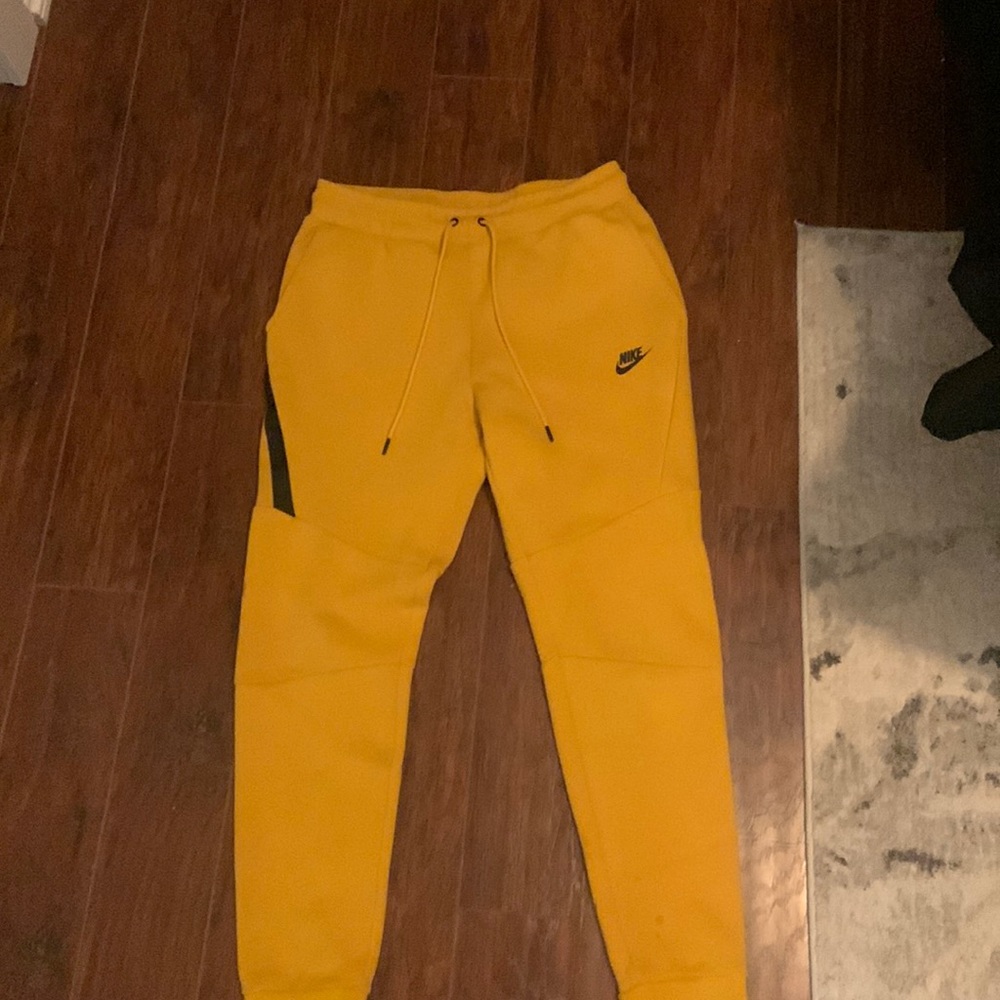 Nike Tech Pants- yellow with black pocket detail.